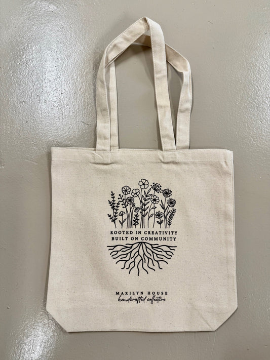 "Rooted in Creativity, Built On Community" Maxilyn House Canvas Tote Bag