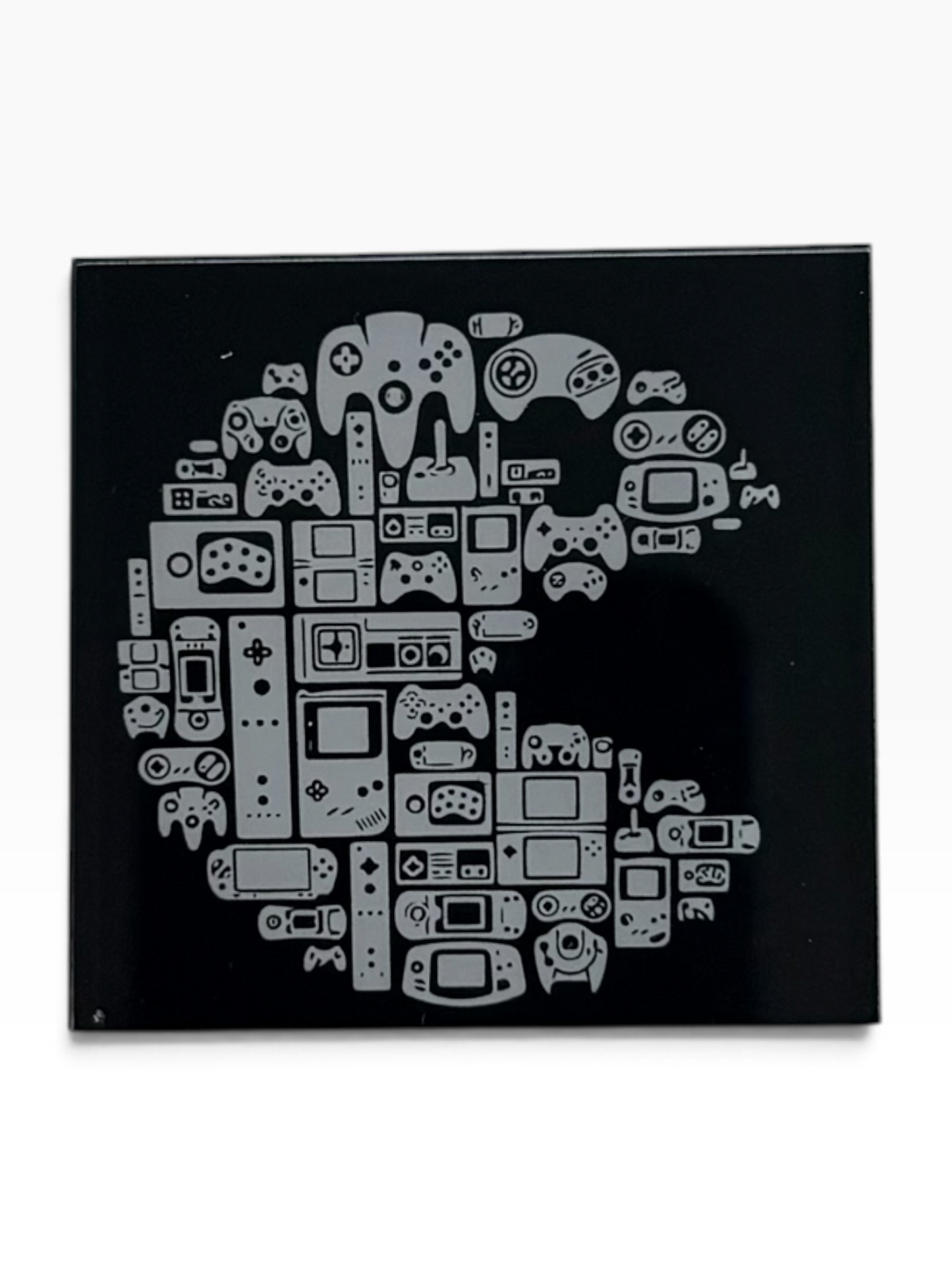 Black acrylic magnet with uv printed backing featuring a white collage of retro gaming controllers, handheld systems and consoles by Madimus