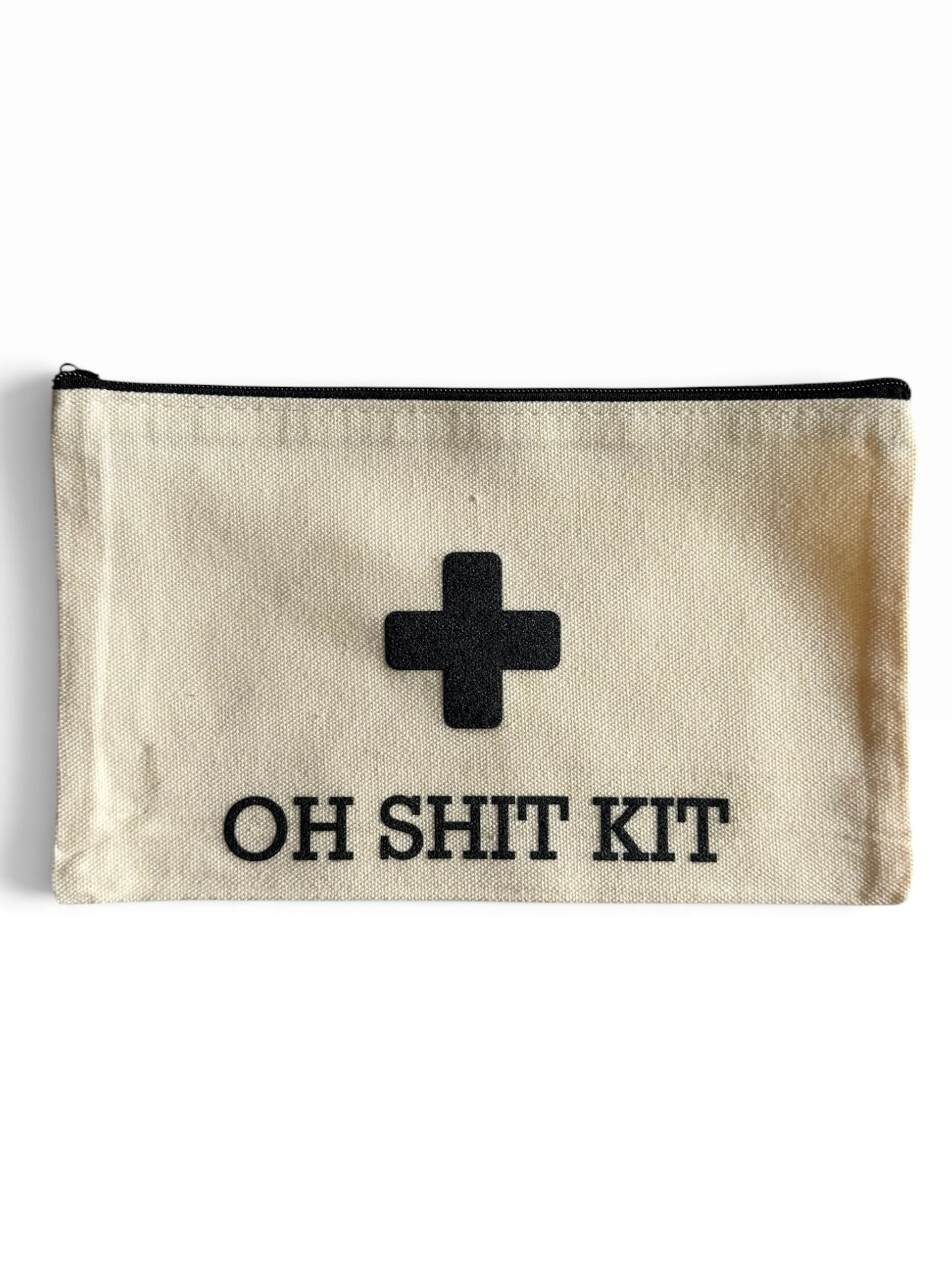 An off-white canvas pouch with a black zipper, featuring a black uv printed medical-style cross and the text 'OH SHIT KIT' in black capital letters.