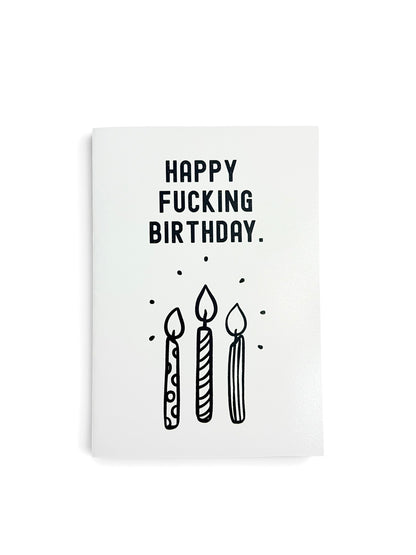 A white greeting card with black text reading 'HAPPY FUCKING BIRTHDAY.' and a simple black line drawing of three candles, shown on a white background.