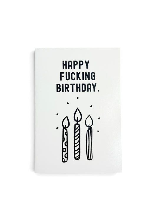 A white greeting card with black text reading 'HAPPY FUCKING BIRTHDAY.' and a simple black line drawing of three candles, shown on a white background.