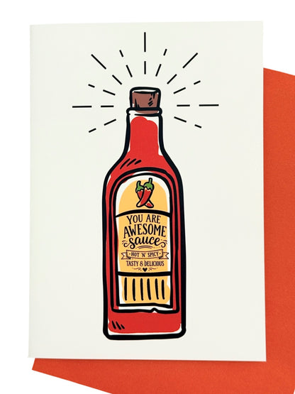 A greeting card with a white background featuring a hand-drawn illustration of a hot sauce bottle with the text 'YOU ARE AWESOME Sauce' and 'HOT & SPICY TASTY & DELICIOUS' and a hot pepper illustration above it. Shown with a red envelope behind it.