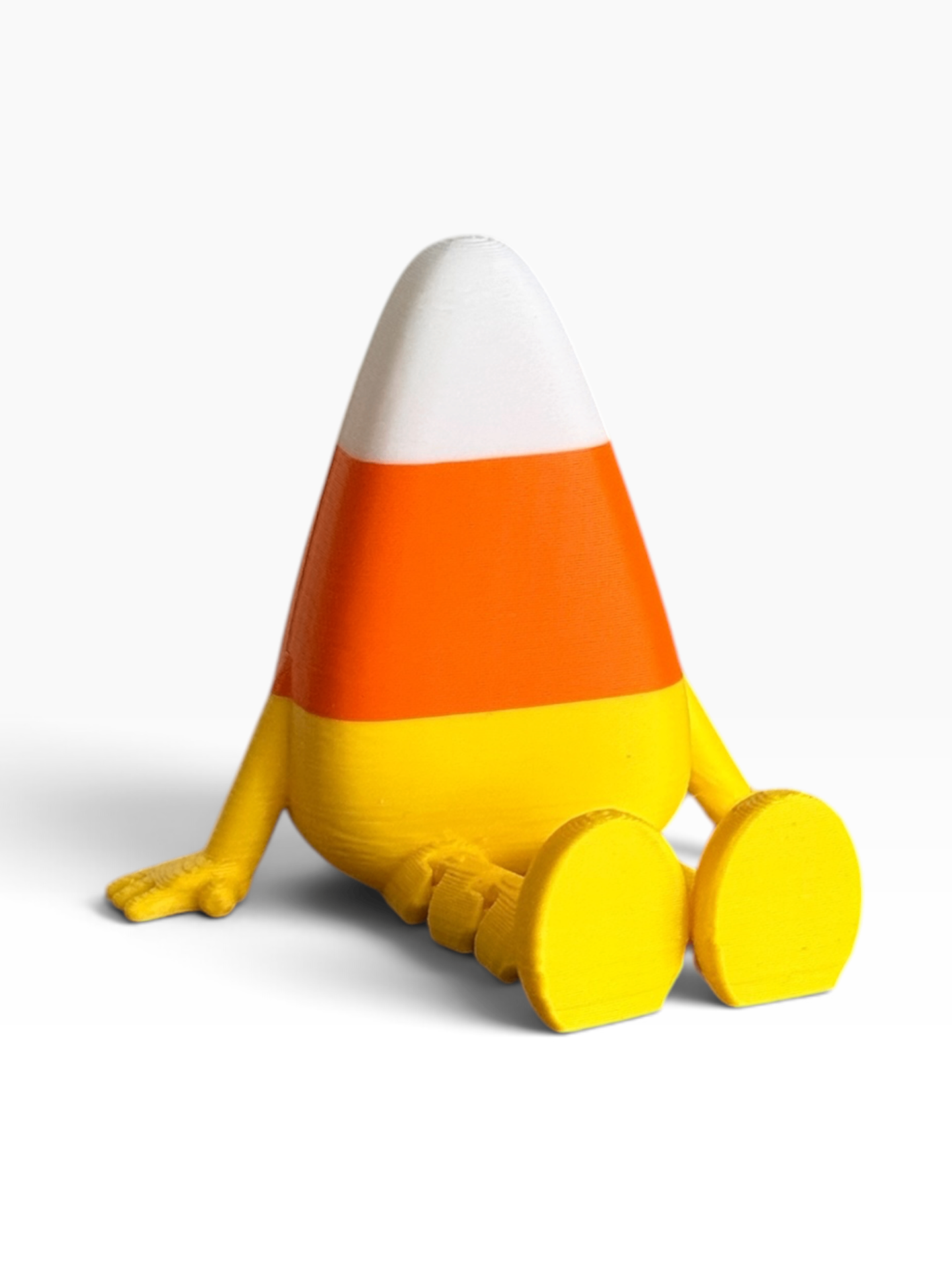 A 3D-printed figure shaped like a seated candy corn, featuring white, orange, and yellow color-blocked sections with small yellow arms and feet, shown on a clean white background.