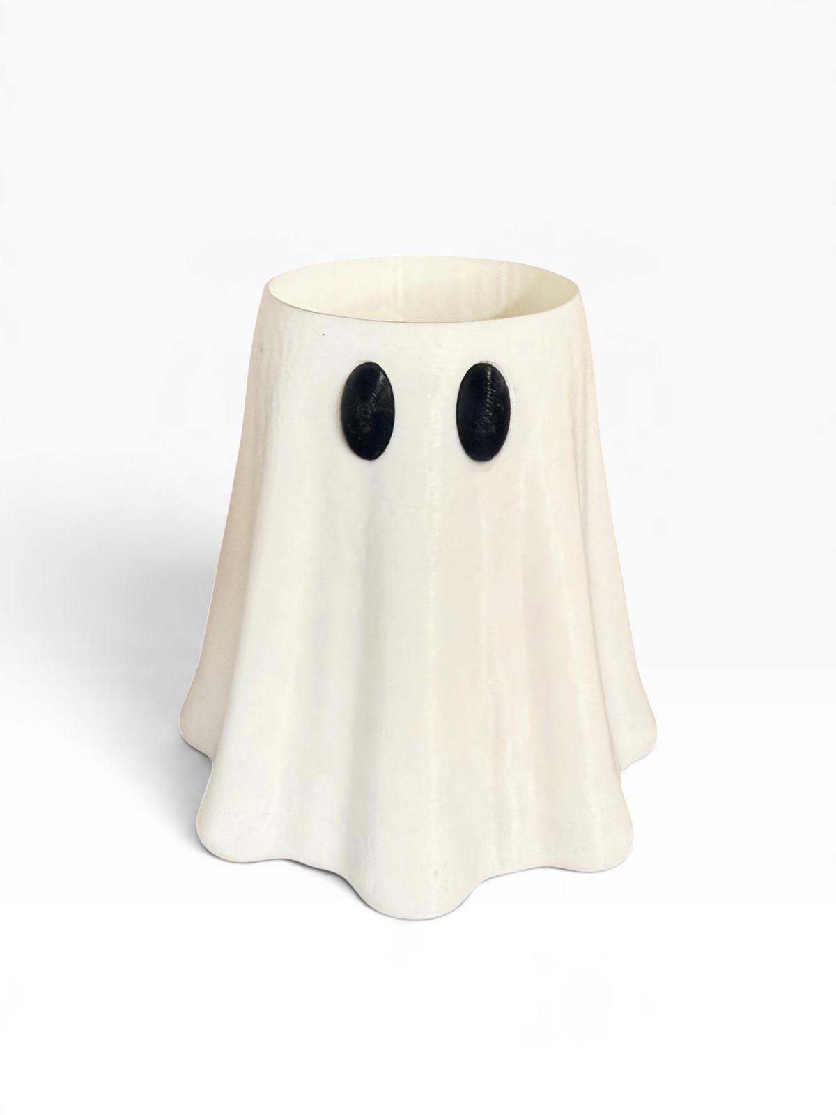 An off-white 3D printed ghost-shaped slim can holder with black oval eyes, photographed on a clean white background.