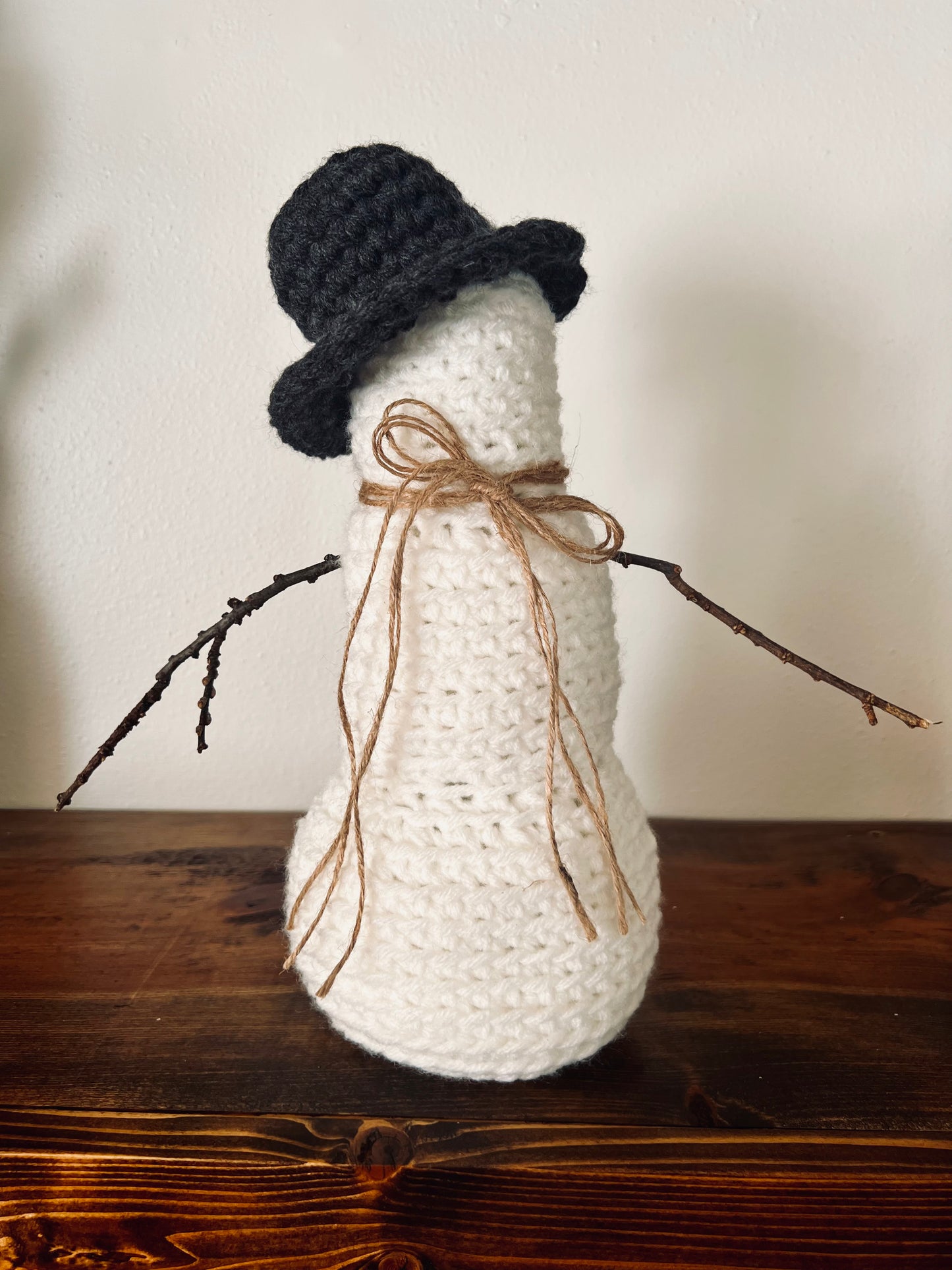 crocheted snowman on shelf