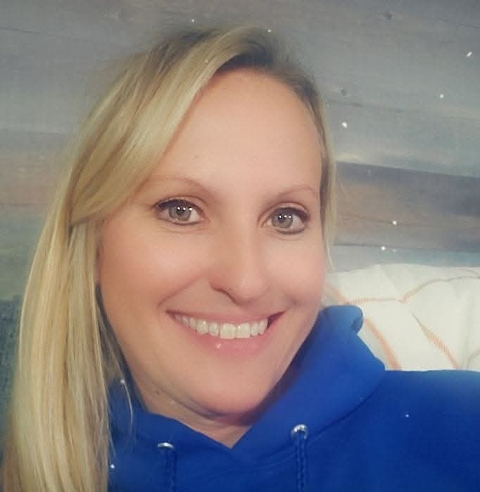 Woman wearing a blue jacket with a blurred background