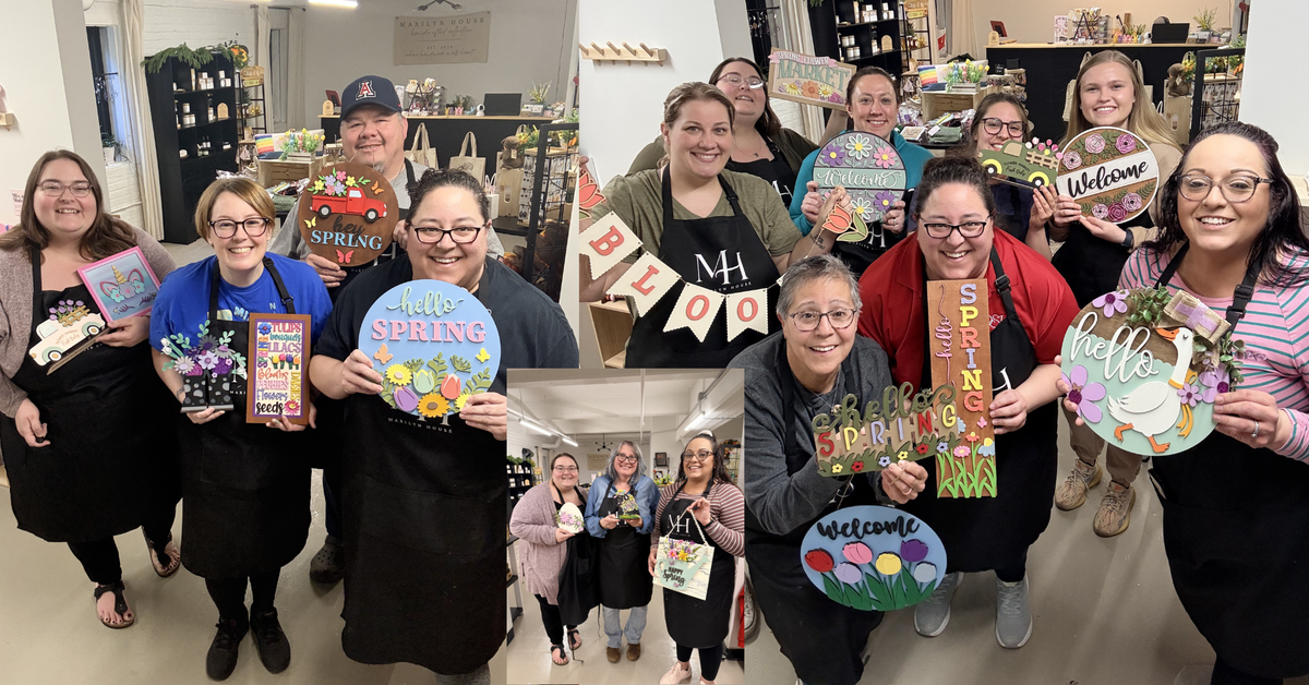Group of people holding colorful signs with various messages in a store setting.
