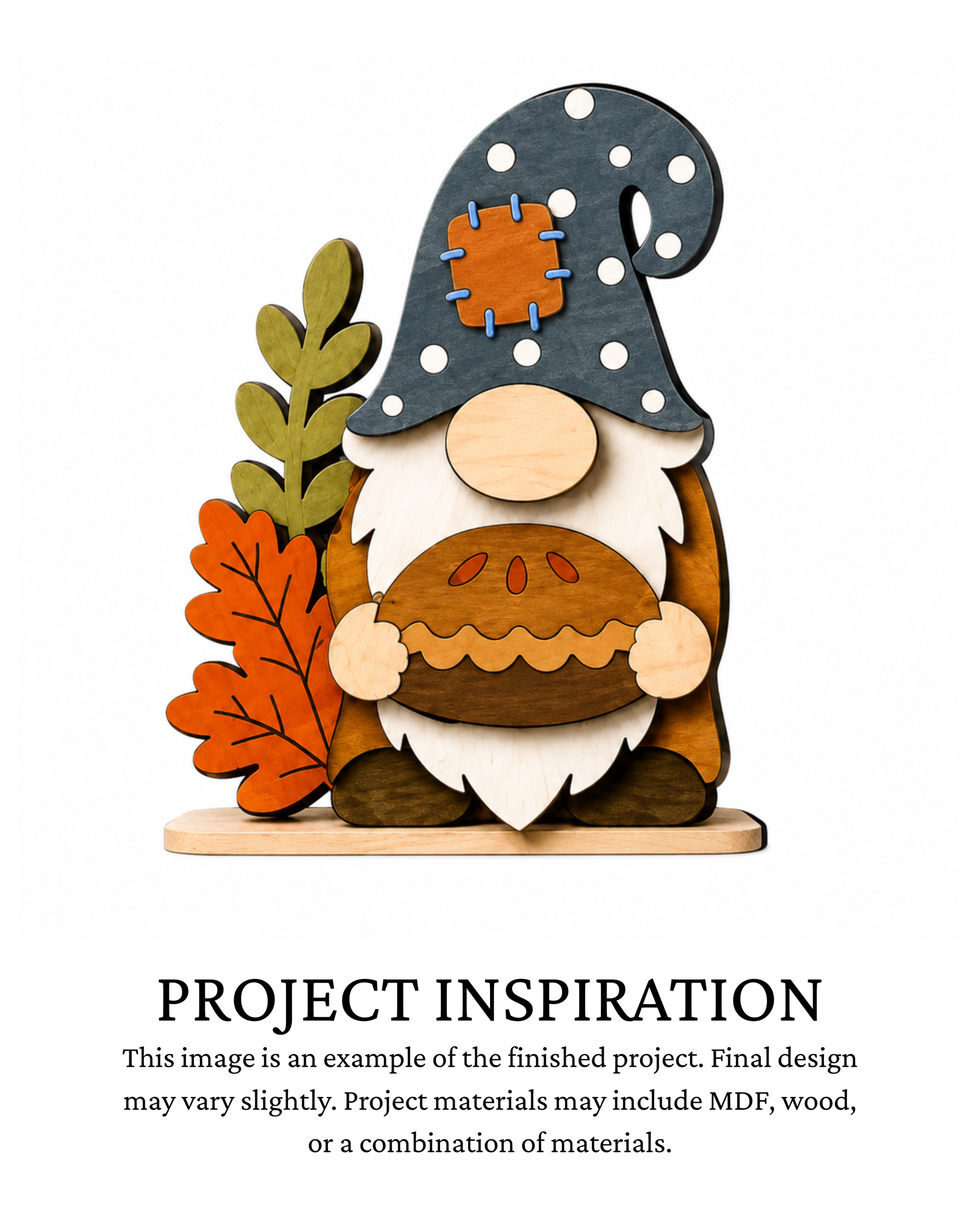 Finished project example of a layered fall gnome shelf sitter wearing a dark polka-dot hat with a patch and holding a fall pie, surrounded by autumn leaves. Text below reads “PROJECT INSPIRATION,” describing it as a finished project example.