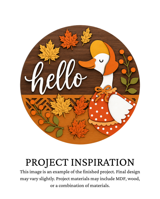 Finished project example of a layered round fall door sign featuring a white goose surrounded by pumpkins and seasonal accents with “Hello Fall” lettering. Text below reads “Project Inspiration.”