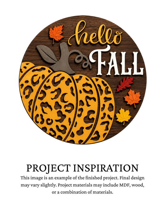 Finished project example of a layered round fall door sign featuring a large orange leopard-print pumpkin, colorful autumn leaves and “Hello Fall” lettering. Text below reads “Project Inspiration.”