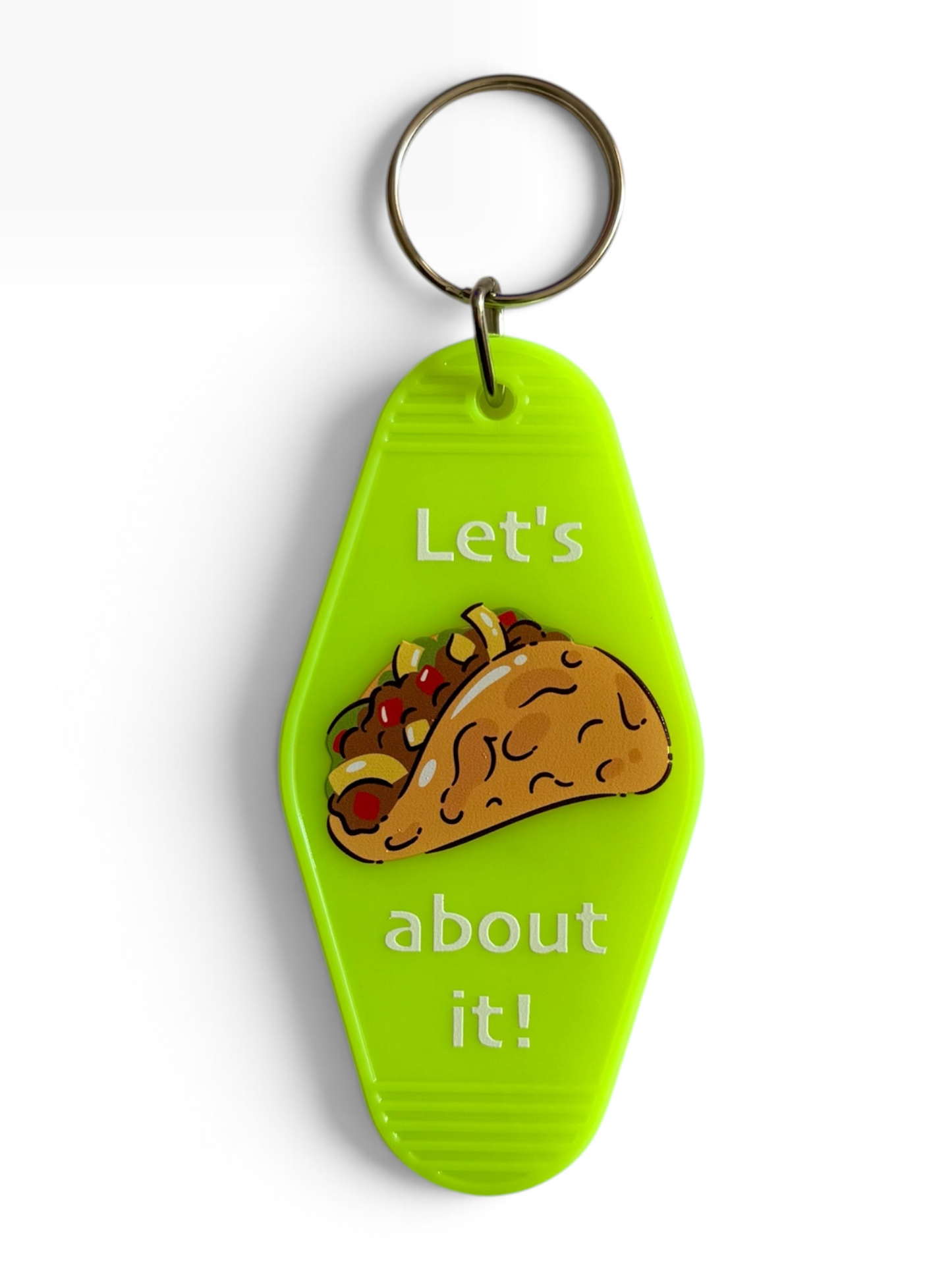 A bright lime green plastic retro hotel keychain with a metal split ring, featuring a cartoon taco graphic and the text 'Let's about it!' in white, shown on a clean white background.