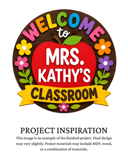 Finished project example of a personalized round classroom door sign featuring a large red apple, colorful flowers and “Welcome to Mrs. Kathy’s Classroom” lettering. Text below reads “PROJECT INSPIRATION,” describing it as a finished project example.