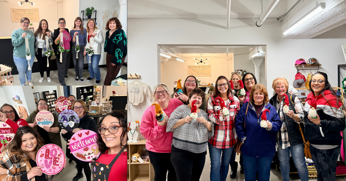 Group of people holding Valentine's Day-themed signs, christmas gnomes and gifts in a store setting. Smiling and showing their finished projects. 